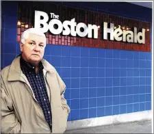  ?? FITZGERALD FAMILY PHOTO ?? Former Herald columnist Joe Fitzgerald stands outside the entrance to the old newsroom in the South End.