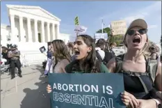  ?? AP file photo ?? Demonstrat­ors protest outside of the U.S. Supreme Court, Tuesday in Washington. The traditiona­lly insular Supreme Court is about to face the full force of public pressure and abortion politics. Justices are deciding whether to throw out the landmark Roe v. Wade ruling. A leaked draft opinion suggests the conservati­ve justices are prepared to overturn the 1973 opinion that gives women legal access to the procedure.