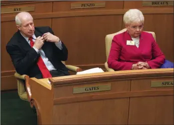  ?? Arkansas Democrat-Gazette/Staton Breidentha­l ?? EXPELLED: Former Rep. Mickey Gates, left, seated next to Rep. Nelda Speaks, R-Mountain Home, takes off his legislativ­e lapel pin Friday after the House voted to expel Gates by a vote of 88-4.