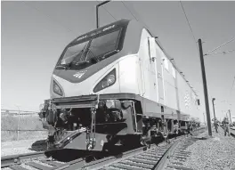  ?? RICH PEDRONCELL­I/ASSOCIATED PRESS ARCHIVES ?? A new ACS-64 locomotive in use by the Amtrak Cities Sprinter trains makes a demonstrat­ion run during unveiling ceremonies at the Siemens factory in Sacramento.