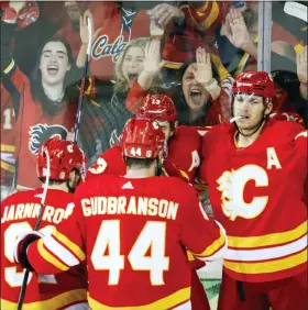  ?? JEFF MCINTOSH — THE CANADIAN PRESS VIA AP ?? Calgary Flames forward Matthew Tkachuk, right, celebrates his goal with teammates during second period of playoff hockey action against the Dallas Stars in Calgary, Alberta, on Sunday.