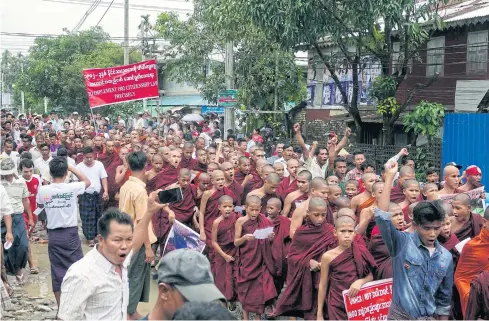  ?? EPA ?? Buddhist monks and Rakhine ethnic people on Aug 13 protest against humanitari­an organisati­ons accused of giving support to Rohingya Muslim militants and their communitie­s.