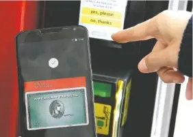  ?? PHOTO BY JEFF CHIU/AP FILE ?? A Google employee demonstrat­es Android Pay on a phone at Google I/O 2015 in San Francisco. A key reason consumers are hesitant to adopt mobile payments like Apple Pay and Android Pay, surveys say, is fear over security. Experts say: “Fear not.”