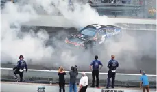  ?? BRIAN SPURLOCK, USA TODAY SPORTS ?? Kasey Kahne does a burnout at Indianapol­is Motor Speedway after his victory ended a nearly three-year winless drought.