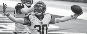  ?? GARY LANDERS/AP ?? Bengals safety Jessie Bates (30), here celebratin­g an intercepti­on against Tennessee on Nov. 1, said the Bengals will have to fortify their defense with the loss of so many offensive weapons.