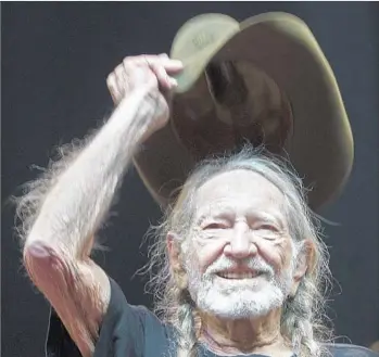  ?? Photograph­s by Allen J. Schaben Los Angeles Times ?? WILLIE NELSON doffs his cowboy hat to fans during his set at Stagecoach on the day he turned 84.