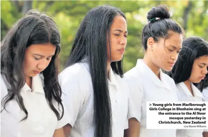 ?? Lisa Maree Williams ?? > Young girls from Marlboroug­h Girls College in Blenheim sing at the entrance to the Al Noor mosque yesterday in Christchur­ch, New Zealand