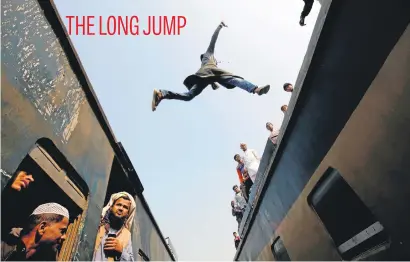  ?? Picture: Reuters ?? A commuter jumps between trains upon arrival at a station to attend Akheri Munajat, the final supplicati­on in the Muslim gathering called Biswa Ijtema in Tongi, Dhaka, Bangladesh, yesterday.