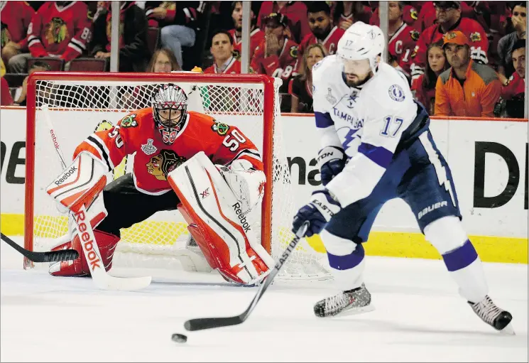  ?? — AP ?? Chicago Blackhawks goalie Corey Crawford keeps his eyes on the puck as it’s handled by Tampa Bay Lightning’s Alex Killorn during Game 4 on Wednesday night.