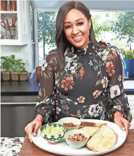  ?? ZAC HAHN ?? Tia Mowry shows the makings of avocado toast on her Cooking Channel show, “Tia Mowry At Home.”