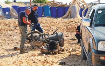  ?? Reuters ?? A police officer inspects the remains of a rocket booster that, according to Israeli authoritie­s, critically injured a 7-year-old girl, after Iran launched drones and missiles towards Israel, near Arad, yesterday.