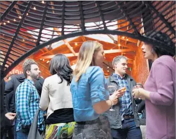  ?? Photograph­s by Christina House For The Times ?? EMPLOYEES FOR Bully Pulpit Interactiv­e, a marketing and communicat­ions agency, mingle at a bar in San Francisco. Many veterans of Washington politics are lured west, putting their skills to work in Silicon Valley.