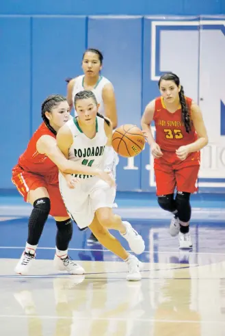  ?? LUIS SÁNCHEZ SATURNO/THE NEW MEXICAN ?? Española Valley’s Kaylinn Martinez, left, covers Pojoaque Valley’s Taylor Roybal during the third quarter of Thursday’s Lady Horsemen Christmas Tournament game at St. Michael’s High School. Pojoaque won 68-55, extending its tournament record to 2-0.