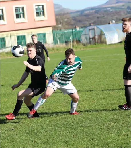  ??  ?? Johnny Martyn of Carbury battles with Eoin Nicholson of Strand Celtic. Pics: Carl Brennan.