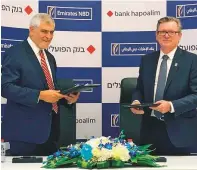  ??  ?? ● Bank Hapoalim CEO Dov Kotler and Emirates NBD CEO Shayne Nelson after the signing of the Memorandum of Understand­ing