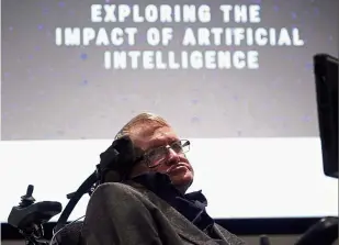  ?? — AFP ?? Man and machines: Hawking arriving to attend the launch of the centre at the University of Cambridge in eastern England.