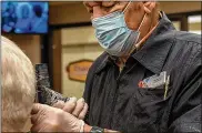  ?? U.S. AIR FORCE PHOTO/AIRMAN 1ST CLASS ALEXANDRIA FULTON ?? Richard Roe, the only master barber in the WrightPatt­erson AFB Barber Shop, has been there since 1978, working in the same chair the whole time and has never changed stations.