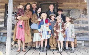  ?? Quantrell Colbert NBC ?? JENNIFER NETTLES playing Mama holds the youngest Parton of yore with Ricky Schroder as Daddy beside her along with the siblings in Dolly Parton’s TV-movie sequel, “Christmas of Many Colors: Circle of Love.”