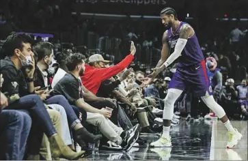  ?? Robert Gauthier Los Angeles Times ?? PAUL GEORGE slaps hands with a fan late in a Clippers win at Staples Center, where George has heard the “M-V-P” chants. “I think he’s playing at the best level ... that he’s been in,” teammate Reggie Jackson says.