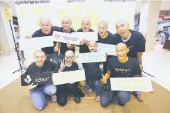  ??  ?? The first group of cancer survivors and parents show off their shaved heads at Go Bald Kuching 2018.