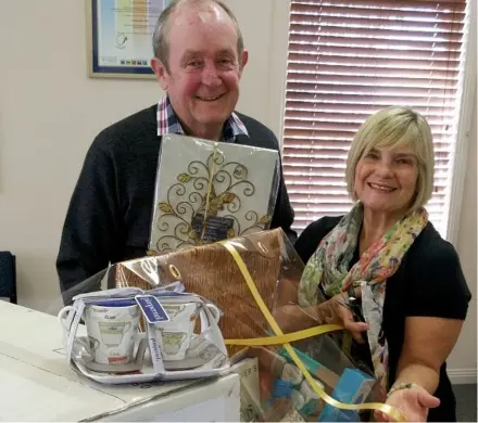  ?? Photo: Contribute­d ?? RACE DAY: Hospice chairman Graham Barron and hospice volunteer Barb Bissett prepare some of the many prizes to be won at this year’s hospice race day.