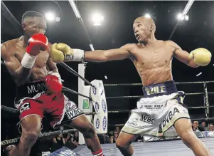  ?? / NICK LOURENS ?? Azinga Fuzile, right, will defend his IBF title on April 8. He is seen here destroying Tshifhiwa Munyai in October.