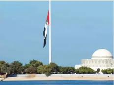 ?? Abdul Rahman/Gulf News ?? The national flag flies at half mast near Abu Dhabi Corniche.