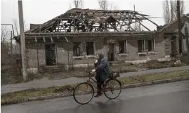  ?? Photograph: Anadolu Agency/Getty Images ?? A cyclist passes a ruined building in Lyman, Donetsk Oblast, Ukraine, 27 November 2022.