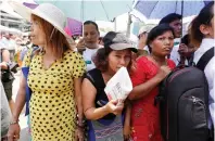  ?? Reuters ?? Family members, of some of the 8,000 inmates granted amnesty by myanmar’s President win myint to mark myanmar’s new year, wait outside prison in Yangon, on Tuesday. —