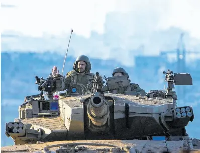  ?? AP ?? Israeli soldiers drive a tank on the border with the Gaza Strip, as seen from southern Israel.