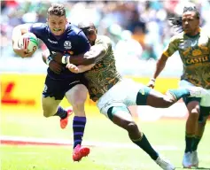  ??  ?? Scotland’s Max Mcfarland (left) is tackled by South Africa’s Siviwe Soyzwapi (right) during the quarter final between Scotland and South Africa on the second and last day of the Rugby Sevens tournament at the Cape Town Stadium in Cape Town. — AFP photo