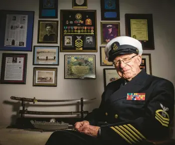  ?? APRIL GAMIZ PHOTOS/THE MORNING CALL ?? Mathias Gutman, 97, of Allentown, sits in his Navy uniform. Gutman was assigned to a landing ship, tank as coxswain on one of its two Higgins boats in World War II.