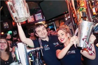 ??  ?? Happy hour: Staff at Galway’s Front Door pub pose with the McCarthy and Irish Press Cups