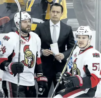  ?? GENE J. PUSKAR/APL ?? Ottawa head coach Guy Boucher, centre, stands behind Viktor Stalberg, left, and Tommy Wingels during the third period of a 7-0 Game 5 loss to the Pittsburgh Penguins on Sunday.