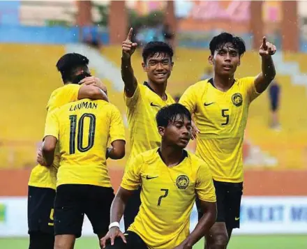  ??  ?? Malaysian players celebrate after defeating Australia 3-0 in the AFF Under-18 championsh­ip yesterday.