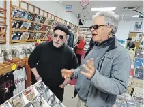  ?? CLIFFORD SKARSTEDT EXAMINER FILE PHOTO ?? Moondance owner Mike Taveroff, left, chats in his George Street store with a customer on April 27, 2018.