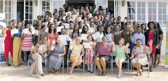  ??  ?? Scholarshi­p recipients and members of the board of The Tryall Fund pose for a photo op after the ceremony.