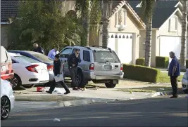  ?? GARY KAZANJIAN — THE ASSOCIATED PRESS ?? Fresno police investigat­e the crime scene Monday in the aftermath of a deadly shooting at a residence on Sunday.