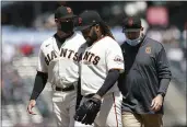  ?? JEFF CHIU — THE ASSOCIATED PRESS ?? Giants starting pitcher Johnny Cueto, middle, walks toward the dugout next to manager Gabe Kapler, left, as he leaves the game during the sixth inning against the Cincinnati Reds on Wednesday.