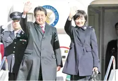  ??  ?? Abe (centre) and his wife Akie (right) wave as they leave Tokyo’s Haneda airport. — AFP photo