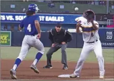  ??  ?? Brawley Union High’s Jude Litrell (left) runs to first base as Southwest High’s Israel Zermeno awaits a throw.