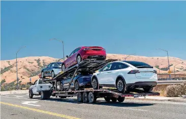  ?? [PHOTO BY DAVID PAUL MORRIS, BLOOMBERG] ?? Tesla vehicles are transporte­d on a truck after leaving the company’s manufactur­ing facility in Fremont, Calif.