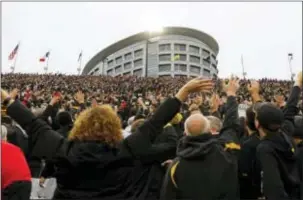  ?? CHARLIE NEIBERGALL — THE ASSOCIATED PRESS ?? Iowa fans wave to children in the University of Iowa’s children’s hospital at the end of the first quarter Saturday in a game against Ohio State in Iowa City,