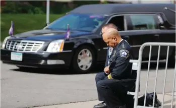  ?? Photo: AP ?? Police officers including Minneapoli­s Police Chief Medaria Arradondo, foreground, take a knee as the body of George Floyd arrives before his memorial services in Minneapoli­s. In the two weeks since Floyd’s killing, police department­s have banned chokeholds, Confederat­e monuments have fallen and officers have been arrested and charged. The moves come amid a massive, nationwide outcry against violence by police and racism.