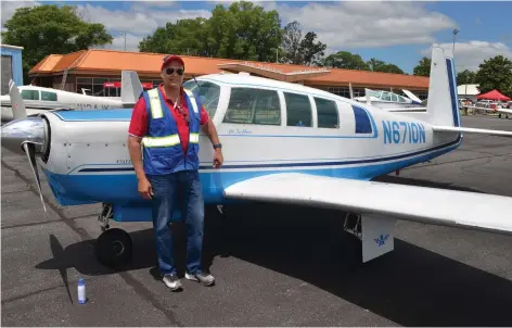  ?? (Special to The Commercial/Richard Ledbetter) ?? Ken Johnson, chairman of the Pine Bluff Aviation Commission, shows off his pristine condition Mooney built in Kerrville, Texas, in 1966. It was the fastest single-engine, retractabl­e landing gear aircraft of its day.