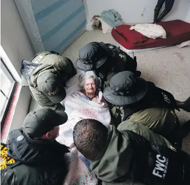  ?? GERALD HERBERT / THE ASSOCIATED PRESS ?? Emergency responders from Louisiana and Florida help transport an elderly woman from the Golden Years Assisted Living home, which was flooded Wednesday from Tropical Storm Harvey, in Orange, Tex.
