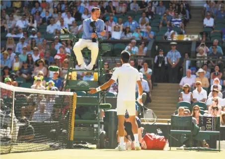  ?? Oli Scarff / AFP / Getty Images ?? Novak Djokovic talks with referee Jake Garner, trying to challenge a call early in his third-round match against Ernests Gulbis.