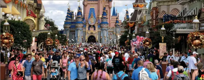  ?? JOE BURBANK — ORLANDO SENTINEL/TNS ?? Crowds fill Main Street USA in front of Cinderella Castle at the Magic Kingdom on the 50th anniversar­y of Walt Disney World, in Lake Buena Vista, Florida, on Oct. 1, 2021.