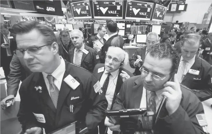  ??  ?? Traders work on the floor of the New York Stock Exchange in New York City. — Reuters photo