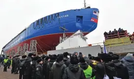  ?? (AFP) ?? People attend the float out ceremony of the nuclear-powered icebreaker Yakutia at the Baltic shipyard in Saint Petersburg on Tuesday